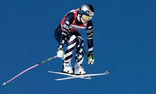 United States' Lindsey Vonn speeds down the course during an alpine ski, women's World Cup downhill, in St. Moritz, Switzerland, Saturday Dec. 13, 2025. (AP Photo/Gabriele Facciotti)