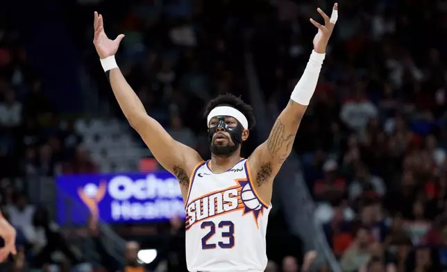 Phoenix Suns guard Jordan Goodwin reacts after a 3-point basket against the New Orleans Pelicans during the second half of an NBA basketball game in New Orleans, Saturday, Dec. 27, 2025. (AP Photo/Matthew Hinton)