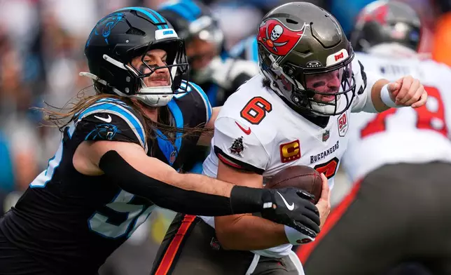 Tampa Bay Buccaneers quarterback Baker Mayfield is sacked by Carolina Panthers linebacker Christian Rozeboom during the first half of an NFL football game, Sunday, Dec. 21, 2025, in Charlotte, N.C. (AP Photo/Erik Verduzco)