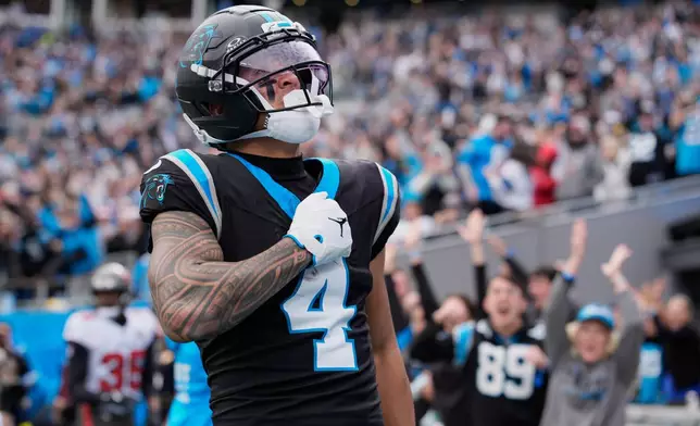 Carolina Panthers wide receiver Tetairoa McMillan celebrates after scoring against the Tampa Bay Buccaneers during the first half of an NFL football game, Sunday, Dec. 21, 2025, in Charlotte, N.C. (AP Photo/Jacob Kupferman)