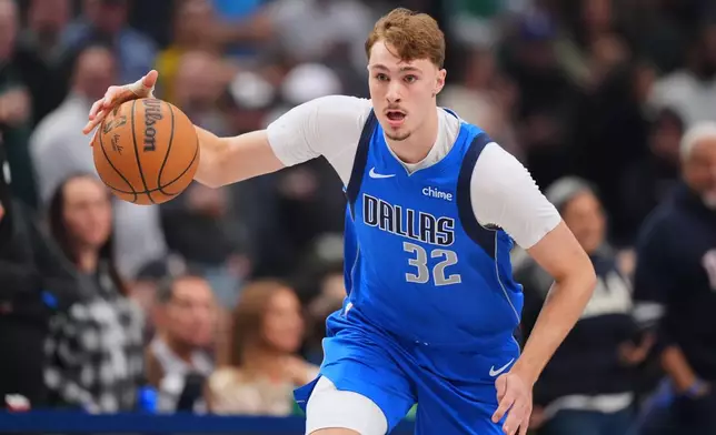 Dallas Mavericks forward Cooper Flagg dribbles the ball up court against the Miami Heat during the first half of an NBA basketball game Wednesday, Dec. 3, 2025, in Dallas. (AP Photo/Julio Cortez)