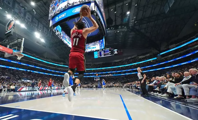Miami Heat forward Jaime Jaquez Jr. tries to keep the ball in bounds against the Dallas Mavericks during the first half of an NBA basketball game Wednesday, Dec. 3, 2025, in Dallas. (AP Photo/Julio Cortez)