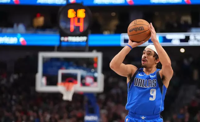 Dallas Mavericks guard Ryan Nembhard prepares to shoot against the Miami Heat during the first half of an NBA basketball game Wednesday, Dec. 3, 2025, in Dallas. (AP Photo/Julio Cortez)