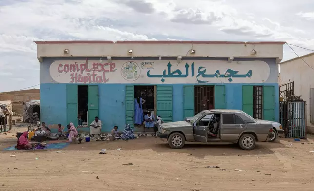 People who fled violence in Mali stand in front of the Bassikounou hospital in the Hodh El Chargui Region, where they found refuge in Mauritania, Nov. 7 2025. (AP Photo/Caitlin Kelly)