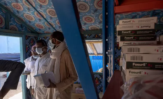 Doctors pick up medicine in the pharmacy of the Douankaran health clinic in the Hodh El Chargui Region, Mauritania, Nov. 7, 2025. (AP Photo/Caitlin Kelly)