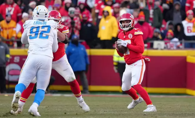Kansas City Chiefs quarterback Gardner Minshew drops back to pass during the second half of an NFL football game against the Los Angeles Chargers Sunday, Dec. 14, 2025, in Kansas City, Mo. (AP Photo/Ed Zurga)