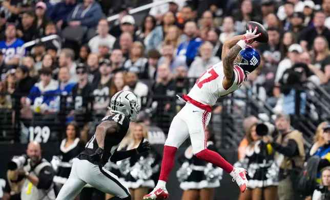 New York Giants wide receiver Wan'Dale Robinson (17) makes a catch against Las Vegas Raiders cornerback Greedy Vance (41) during the first half of an NFL football game Sunday, Dec. 28, 2025, in Las Vegas. (AP Photo/John Locher)