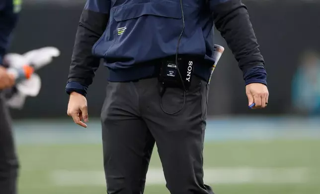 Seattle Seahawks head coach Mike MacDonald watches during the first half of an NFL football game against the Carolina Panthers, Sunday, Dec. 28, 2025, in Charlotte, N.C. (AP Photo/Rusty Jones)