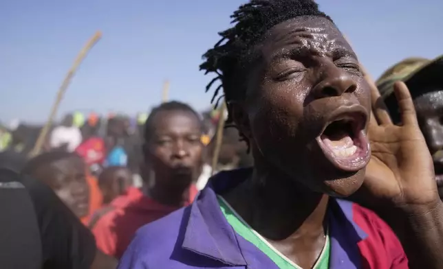 A spectator dances and sings after bull Shakahola won bullfighting match, in Kakamega, Kenya, Saturday, Nov. 29, 2025. (AP Photo/Brian Inganga)