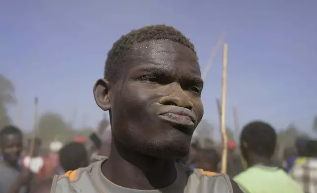 A spectator covered in dust dances after bull Shakahola won bullfighting match, in Kakamega, Kenya, Saturday, Nov. 29, 2025. (AP Photo/Brian Inganga)
