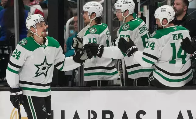 Dallas Stars center Roope Hintz (24) is congratulated by teammates after scoring against the San Jose Sharks during the first period of an NHL hockey game in San Jose, Calif., Thursday, Dec. 18, 2025. (AP Photo/Jeff Chiu)