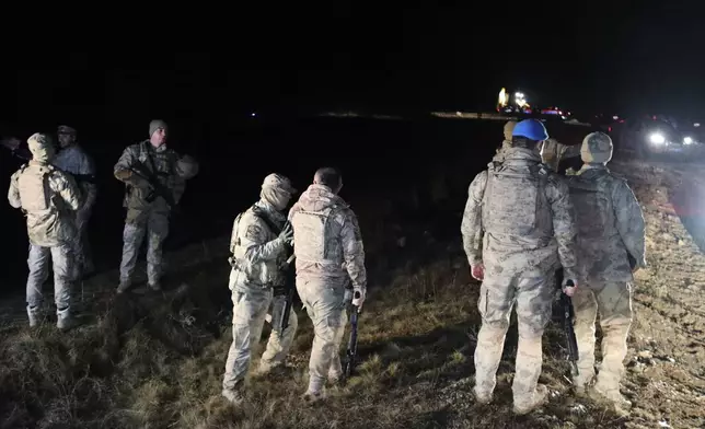 Turkish soldiers and rescue teams search for the remains of a private jet carrying Libya's military chief and four others that crashed after taking off from Ankara, killing everyone on board, in Ankara, Turkey, Tuesday, Dec. 23, 2025. (AP Photo/Efekan Akyuz)