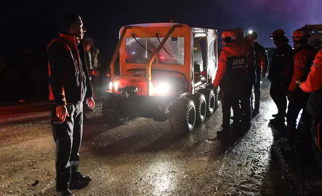 Turkish rescue teams search for the remains of a private jet carrying Libya's military chief and four others that crashed after taking off from Ankara, killing everyone on board, in Ankara, Turkey, Tuesday, Dec. 23, 2025. (AP Photo/Efekan Akyuz)