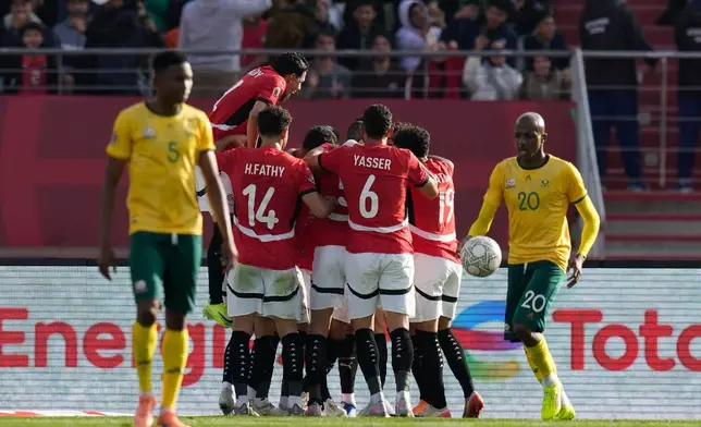Egypt players celebrate after Egypt's Mohamed Salah scores during the Africa Cup of Nations group B soccer match between Egypt and South Africa in Agadir, Morocco, Friday, Dec. 26, 2025. (AP Photo/Themba Hadebe)