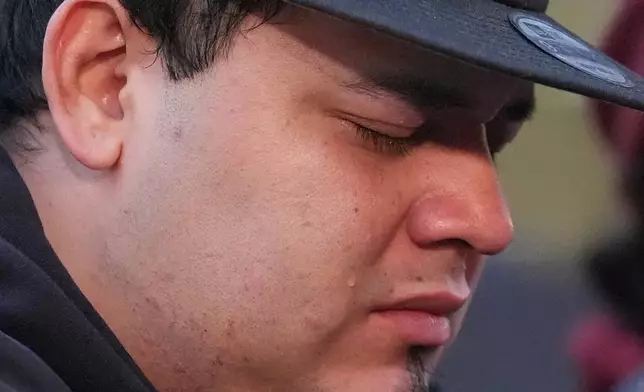 Kilmar Abrego Garcia cries during a rally ahead of a mandatory check at the Immigration and Customs Enforcement office in Baltimore, Friday, Dec. 12, 2025, after he was released from detention on Thursday under a judge's order. (AP Photo/Stephanie Scarbrough)