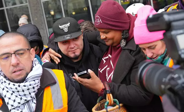 Kilmar Abrego Garcia, center, leaves with Lydia Walther-Rodriguez, right, of Casa in Maryland, after a mandatory check at the Immigration and Customs Enforcement office in Baltimore, Friday, Dec. 12, 2025, after he was released from detention on Thursday under a judge's order. (AP Photo/Stephanie Scarbrough)