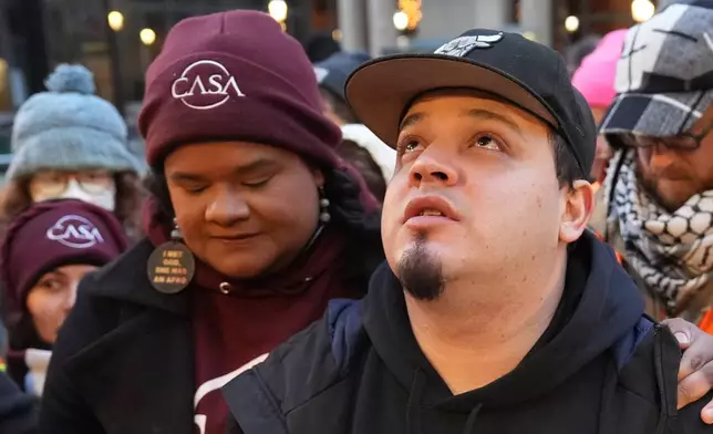 Kilmar Abrego Garcia waits with Lydia Walther-Rodriguez of Casa in Maryland, left, to enter the building for a mandatory check at the Immigration and Customs Enforcement office in Baltimore, Friday, Dec. 12, 2025, after he was released from detention on Thursday under a judge's order. (AP Photo/Stephanie Scarbrough)