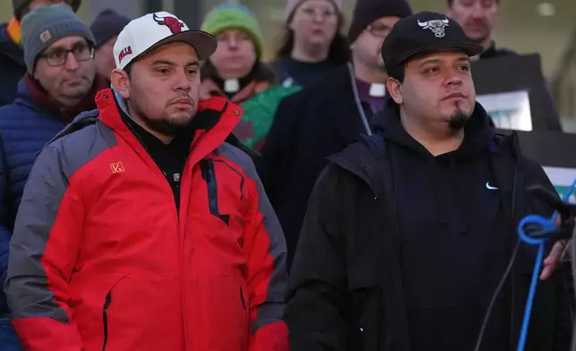 Kilmar Abrego Garcia listens with is brother Cesar Abrego Garcia during a rally ahead of a mandatory check at the Immigration and Customs Enforcement office in Baltimore, Friday, Dec. 12, 2025, after he was released from detention on Thursday under a judge's order. (AP Photo/Stephanie Scarbrough)