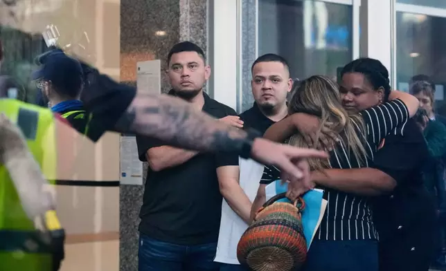 Kilmar Abrego Garcia, center, and his brother Cesar Abrego Garcia, left, arrive at the Immigration and Customs Enforcement field office in Baltimore, Aug. 25, 2025. (AP Photo/Stephanie Scarbrough, File)