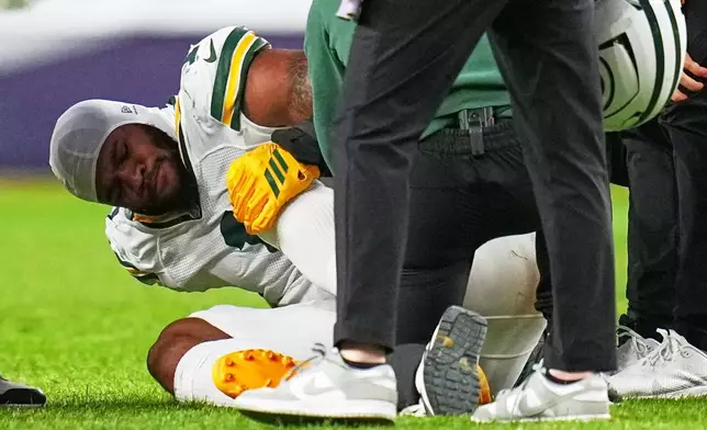 Green Bay Packers' Micah Parsons reacts after an injury during the second half of an NFL football game against the Denver Broncos Sunday, Dec. 14, 2025, in Denver. (AP Photo/Jack Dempsey)
