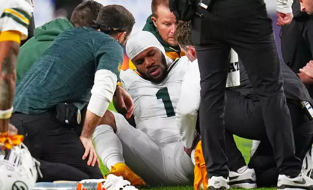 Green Bay Packers' Micah Parsons reacts after an injury during the second half of an NFL football game against the Denver Broncos Sunday, Dec. 14, 2025, in Denver. (AP Photo/Jack Dempsey)