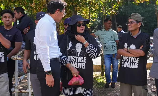Supporters of Malaysia's former Prime Minister Najib Razak gather outside the Kuala Lumpur High Court Complex, in Kuala Lumpur, Malaysia, Monday, Dec. 22, 2025. (AP Photo/Azneal Ishak)