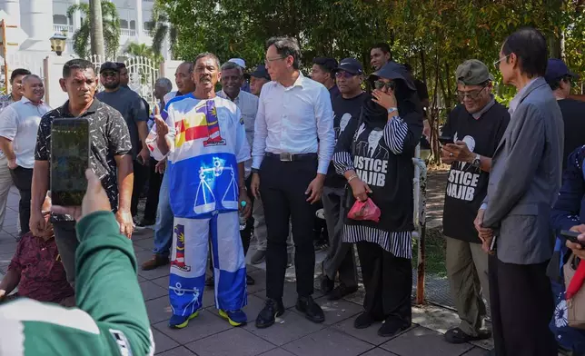 Supporters of Malaysia's former Prime Minister Najib Razak gather outside the Kuala Lumpur High Court Complex, in Kuala Lumpur, Malaysia, Monday, Dec. 22, 2025. (AP Photo/Azneal Ishak)