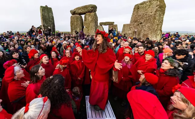 People celebrate the Winter Solstice sunrise celebrations at Stonehenge, a world-famous prehistoric monument on Salisbury Plain, England, Sunday, Dec. 21, 2025.(AP Photo/Anthony Upton)