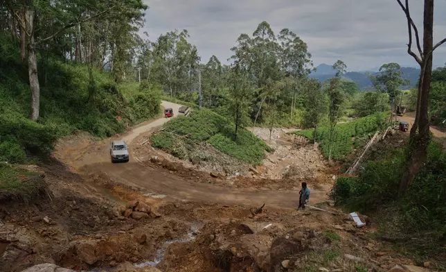 Vehicles move across a stretch of tea plantation destroyed by a landslide following Cyclone Ditwah in Craighead Estate in Nawalapitiya, Sri Lanka, Friday, Dec.12, 2025. (AP Photo/Eranga Jayawardena)