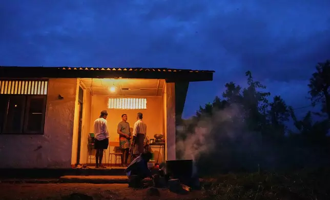 Tea plantation workers and their children who evacuated after Cyclone Ditwah led to floods and landslides take shelter at a safety center at Craighead Estate in Nawalapitiya, Sri Lanka, Thursday, Dec, 11, 2025. (AP Photo/Eranga Jayawardena)