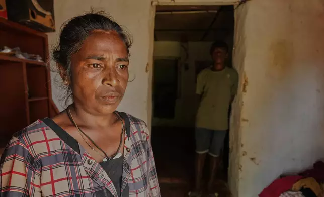 Arumugam Manikavalli stands at the doorway to her living quarters after Cyclone Ditwah led to floods and landslides at Craighead Estate in Nawalapitiya, Sri Lanka, Friday, Dec.12, 2025. (AP Photo/Eranga Jayawardena)