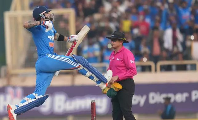 India's Virat Kohli celebrates his century during the first One Day International match between India and South Africa in Ranchi, India, Sunday, Nov. 30, 2025. (AP Photo/Rafiq Maqbool)
