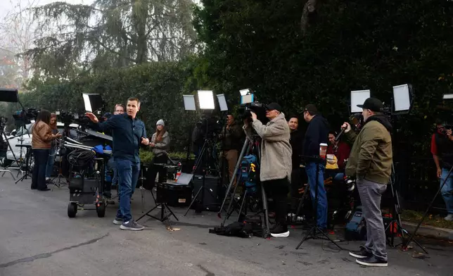 News crews stage outside Rob Reiner's residence Monday, Dec. 15, 2025, in the Brentwood section of Los Angeles. (AP Photo/Caroline Brehman)
