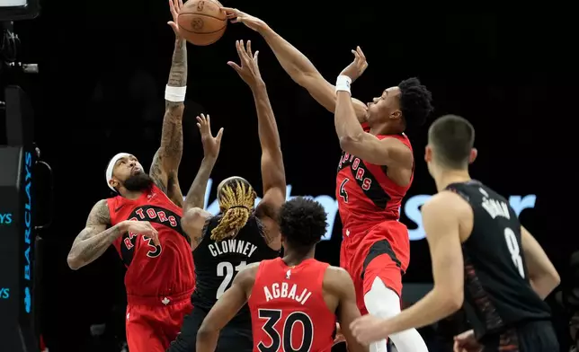 Toronto Raptors forward Scottie Barnes (4) blocks Brooklyn Nets forward Noah Clowney (21) during the first half of an NBA basketball game, Sunday, Dec. 21, 2025, in New York. (AP Photo/Yuki Iwamura)