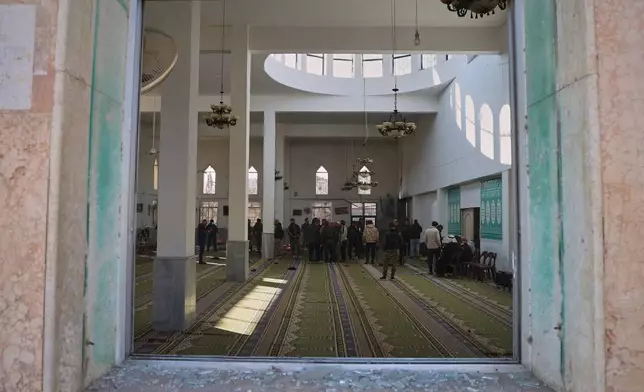 Syrian security forces inspect the damage after an explosion in the Imam Ali bin Abi Talib Mosque in a predominantly Alawite area of the Wadi al-Dhahab neighborhood in Homs, Syria Friday, Dec. 26, 2025.(AP Photo)