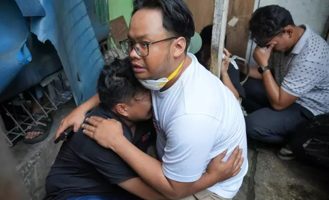 A man cries at the site of a fire in Jakarta, Indonesia, Tuesday, Dec. 9, 2025. (AP Photo/Dita Alangkara)