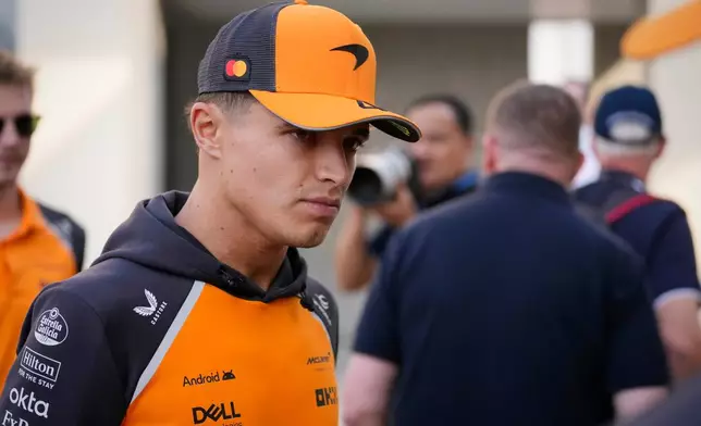 McLaren driver Lando Norris of Britain walks through the paddock at the Yas Marina Circuit ahead of the Abu Dhabi Grand Prix in Abu Dhabi, United Arab Emirates, Thursday, Dec. 4, 2025. (AP Photo/Darko Bandic)
