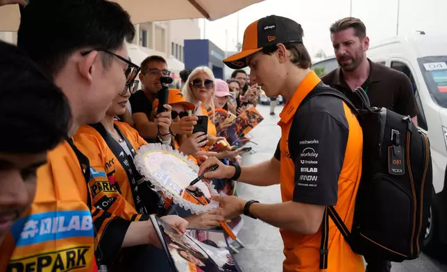 McLaren driver Oscar Piastri of Australia arrives for the first practice for the he Abu Dhabi Formula One Grand Prix in Abu Dhabi, United Arab Emirates, Friday, Dec. 5, 2025. (AP Photo/Darko Bandic)