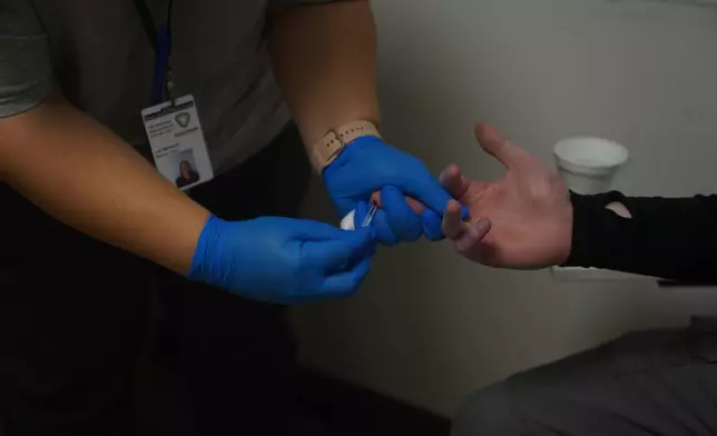 A participant in the syringe exchange program receives a blood draw during a visit at the Clark County Health Department Tuesday, Nov. 23, 2025, in Jeffersonville, Ind. (AP Photo/Obed Lamy)
