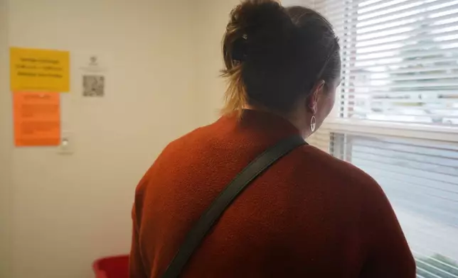 A participant in the syringe exchange program stands in an exam room at the Clark County Health Department Tuesday, Nov. 23, 2025, in Jeffersonville, Ind. (AP Photo/Obed Lamy)