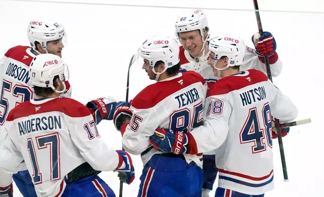 Montréal Canadiens' Alexandre Texier (85) celebrates with teammates after scoring during the first period of an NHL hockey game against the Pittsburgh Penguins, Thursday, Dec. 11, 2025, in Pittsburgh. (Matt Freed/Pittsburgh Post-Gazette via AP)