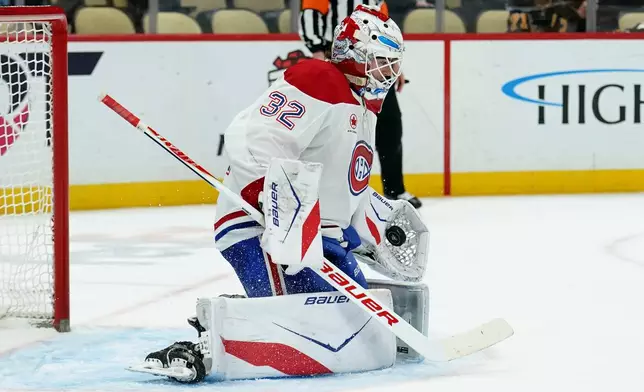 Montréal Canadiens goaltender Jacob Fowler (32) makes a save during the second period of an NHL hockey game against the Pittsburgh Penguins, Thursday, Dec. 11, 2025, in Pittsburgh. (Matt Freed/Pittsburgh Post-Gazette via AP)