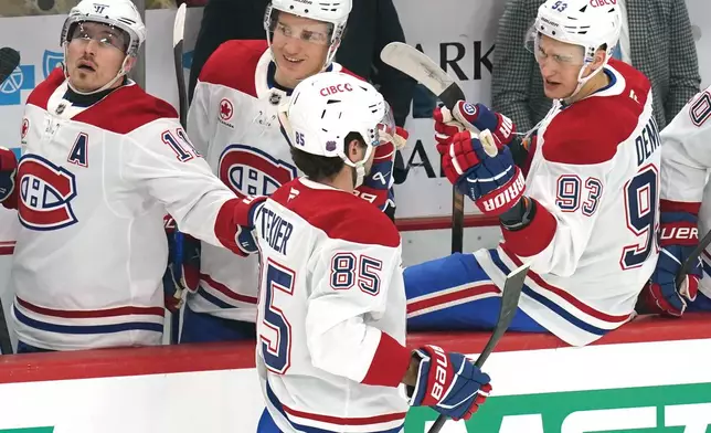 Montréal Canadiens' Alexandre Texier (85) returns to the bench after scoring during the first period of an NHL hockey game against the Pittsburgh Penguins, Thursday, Dec. 11, 2025, in Pittsburgh. (Matt Freed/Pittsburgh Post-Gazette via AP)