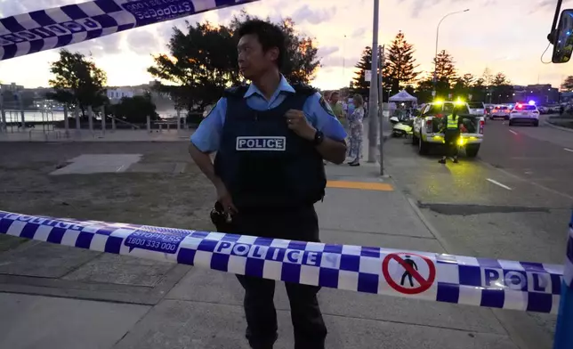 Police cordon off an area at Bondi Beach after a reported shooting in Sydney, Sunday, Dec. 14, 2025. (AP Photo/Mark Baker)