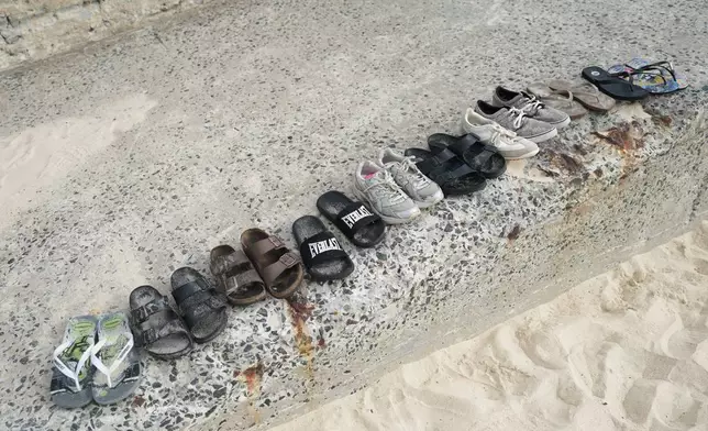 Shoes sit lined up following a shooting the day prior at Sydney's Bondi Beach, Monday, Dec. 15, 2025. (AP Photo/Mark Baker)