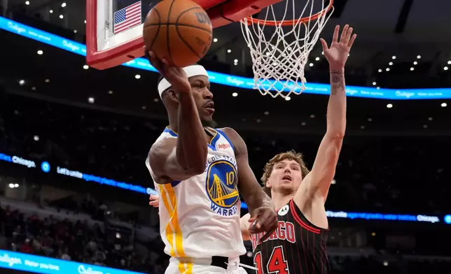 Golden State Warriors forward Jimmy Butler III, left, is defended by Chicago Bulls forward Matas Buzelis, right, during the second half of an NBA basketball game Sunday, Dec. 7, 2025, in Chicago. (AP Photo/David Banks)