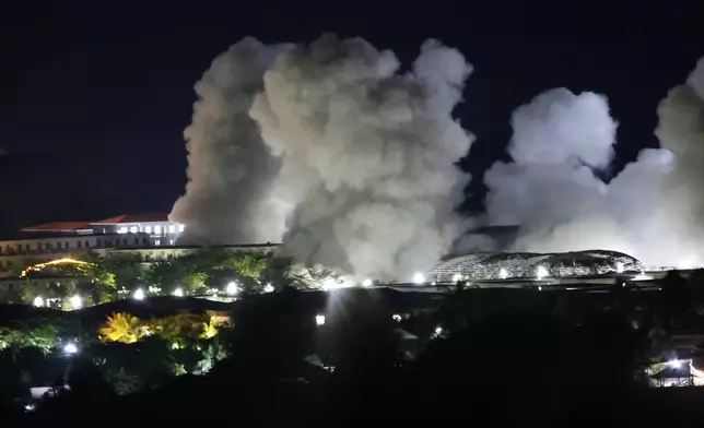 FILE - White smoke billows after an explosion at KK Park online scam center in Myawaddy township, Karen State, Myanmar, Saturday, Oct. 25, 2025. (AP Photo/Sarot Meksophawannakul, File)