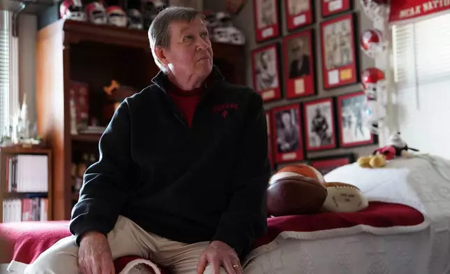 Bill Murphy sits on a bed and looks at memorabilia hanging on the wall in a room at his home in Greenfield, Ind., on Wednesday, Dec. 17, 2025. (AP Photo/Obed Lamy)