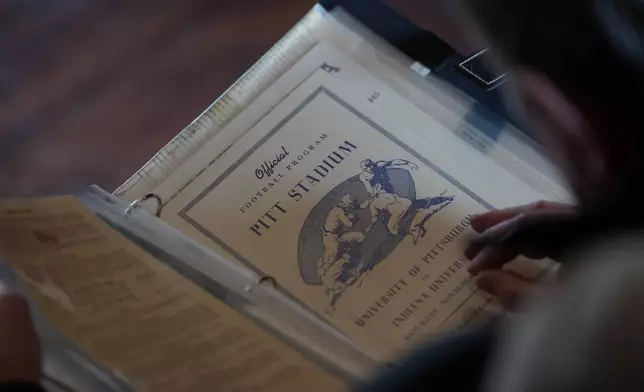 A vintage sports program sits in a photo album collected by Bill Murphy, 77, an Indiana football fan, at his home in Greenfield, Ind., Wednesday Dec. 17, 2025. (AP Photo/Obed Lamy)