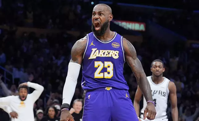 Los Angeles Lakers forward Lebron James (23) reacts after making a dunk during the first half of an NBA Cup basketball game against the San Antonio Spurs Wednesday, Dec. 10, 2025, in Los Angeles. (AP Photo/Jae C. Hong)